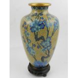 A 20th century Chinese cloisonne baluster vase, decorated with blossoms on a gold ground. H.26cm