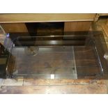 A Contemporary smoke glass topped coffee table, having tubular chrome base. H.39cm L.150cm D.74cm