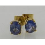 A pair of sapphire ear studs, claw set in yellow metal stamped 18kt, 3.2g