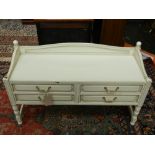 A Contemporary cream painted chest of four drawers, raised on turned supports and stretchers. H.66cm