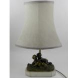 A 20th century table lamp, the bronze base in the form of two children fighting over grapes,