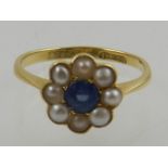 A 9 carat pearl dress ring, centred with a sapphire.