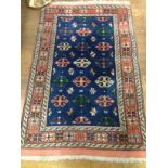 A Persian blue ground prayer rug, decorated with geometric patterns to centre, multi-bordered and