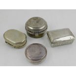 Four white metal pill boxes.