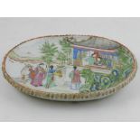 A Chinese Jiaqing period (1795-1820) famille rose oval dish, decorated with greeting figures with