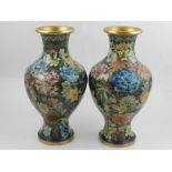 A pair of 20th century Chinese cloisonne vases, decorated with scrolling foliage on a green