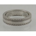 A white metal and cubic zirconia set eternity ring, the shank stamp 925.