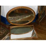 An oval wall mirror, with a bevelled plate within a gold coloured frame, together with a rectangular