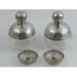 A pair of silver topped scent bottles, hallmarked London 1918, together with two silver pin