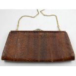 A brown snakeskin hand bag, with gilt metal fittings.