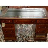 A Victorian leather topped pedestal desk, having one frieze drawer and four short drawers to each