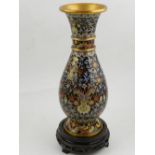 A 20th century Chinese cloisonne vase, decorated with scrolling foliage on a black ground,