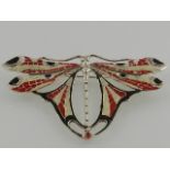 A white metal and enamel brooch, in the form of a dragon fly, stamped Sterling. W.8cm