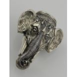 A silver plated vesta case in the form of an elephant's head, having enamel plaque to top with