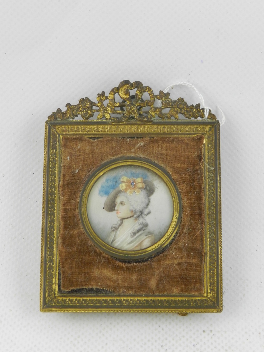 Early 19th Century Continental school, a circular head and shoulder miniature portrait of a lady