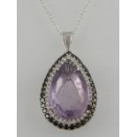 An 18ct white gold amethyst and diamonds set pear shaped pendant, hallmarked London, together with a