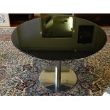 A Contemporary circular glass topped breakfast table. H.74cm D.110cm