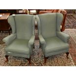 Parker Knoll, England. A pair of 20th century wingback armchairs, upholstered in a blue fabric.