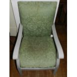 A 20th century grey painted pine arm chair, upholstered in a floral green fabric, raised on square