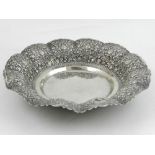 A Continental white metal dish, possibly German, having scrolling foliate repousse decoration. D.