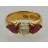 A yellow gold three stone ruby and diamond ring, hallmarked Birmingham.