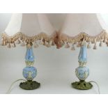 A pair of 20th century French porcelain and brass table lamps.