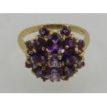 A 9 carat yellow gold and amethyst cluster ring.