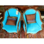 A pair of Louis XV style armchairs, upholstered in a bright blue fabric, raised on carved cabriole