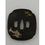 A Japanese bronze tsuba, decorated in yellow and white metal, bears signature.