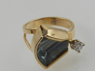 A yellow gold aquamarine and diamond dress ring.