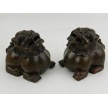 A pair of Chinese cast bronze incense burners, in the form of Dogs of Fo, bears four character