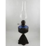 A blue glass oil lamp. H.54cm