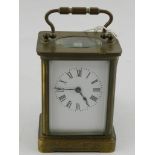 A French brass carriage clock, having corniche case and Roman enamelled dial. H.11cm