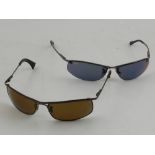 A pair of Ray-Ban gentleman's sunglasses with case, together with another similar pair, (2).