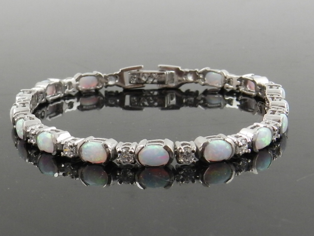 A white metal cubic zirconia and opalite set bracelet, stamped 925.