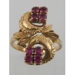 A yellow metal and ruby ring, of naturalistic design, set eight round cut rubies.