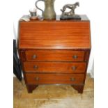 A 20th century mahogany cross-banded bureau, the fall enclosing a fitted interior, above three