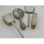 An Art Deco three piece silver ladies dressing table set, indistinct hallmarks, together with one