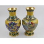 A pair of Chinese cloisonne vases, of baluster form and decorated with dragons on a yellow ground,