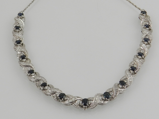 A white metal sapphire and diamond set necklace, the oval cut sapphires claw set on a woven twist