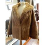 A ladies fur coat, size approx. medium.