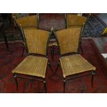 A set of four Contemporary cast metal garden dining chairs, having wicker seat and backrest.