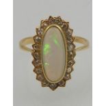 A yellow metal opal and diamond dress ring, diamonds approx.1ct.