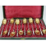A cased set of early 20th century Russian white and yellow metal teaspoons, stamped 84.