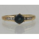 A yellow metal and topaz ring,