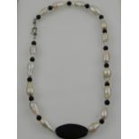 A black onyx and pearl beaded necklace.