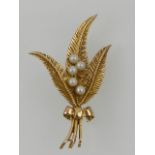 A 9 carat yellow gold and pearl brooch, fashioned as three fern leaves.