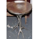 An occasional table with a silver metal antler base
