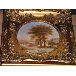 A gilt frame circular print of a rural scene, dia:17.