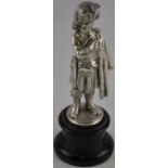 An Edwardian white metal cast figure of a Scotts Guard on ebonised plinth